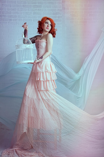 Sensual young woman with red hairs posing in studio