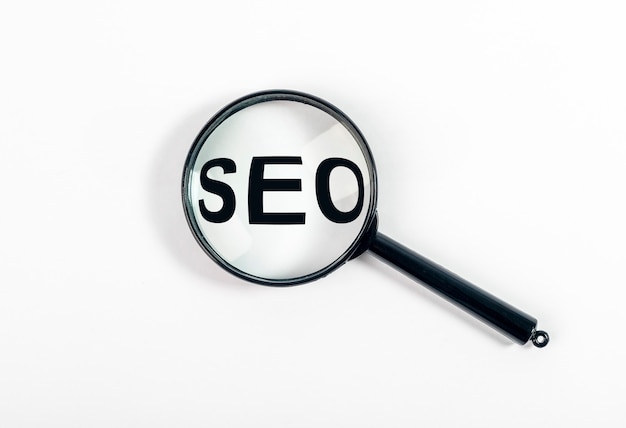 SEO word, acronym through magnifying glass or loupe