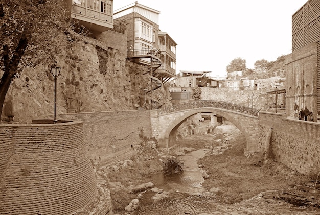 Sepia Image of Bridge of Lovers with Love's Padlocks on Railing in Old Tbilisi Georgia