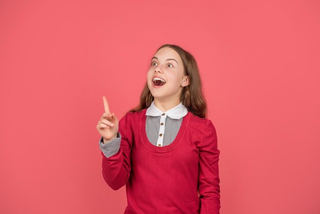 September 1. child on red background. express emotions. inspired glad teen girl. back to school. knowledge day. childhood education. kid in uniform.