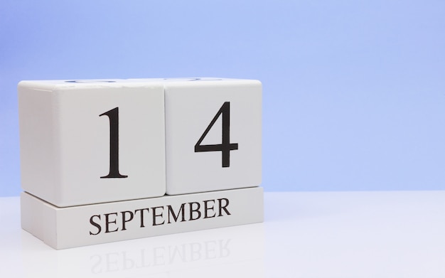 September 14st. Day 14 of month, daily calendar on white table with reflection