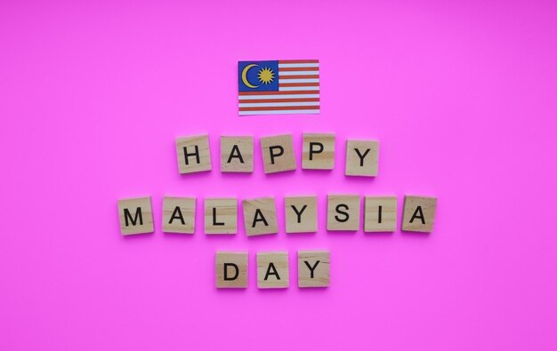 September 16 happy Malaysia Day flag of Malaysia minimalistic banner with the inscription in wooden letters