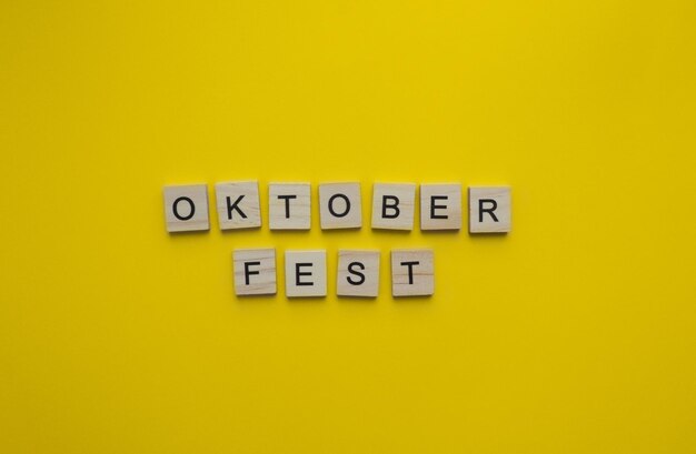 September 16 october 3 oktoberfest minimalistic banner with the inscription in wooden letters on an orange background