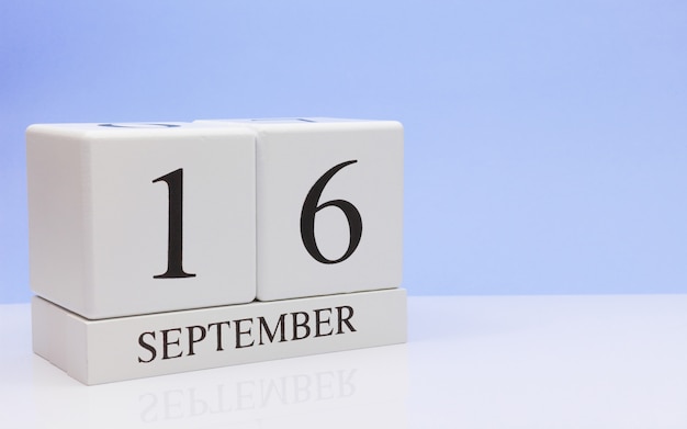 September 16st. Day 16 of month, daily calendar on white table with reflection