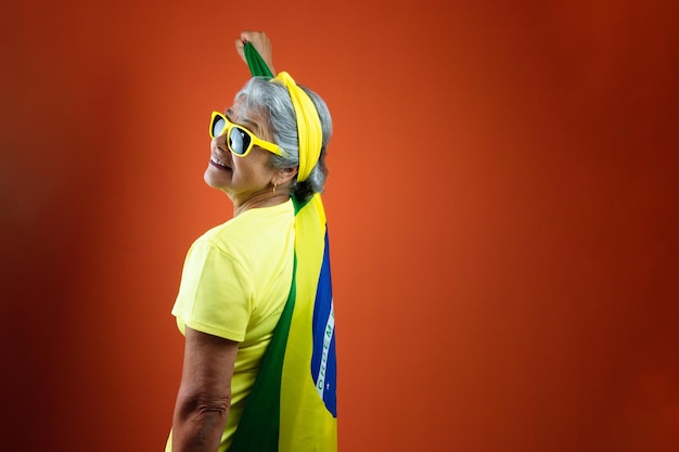 September 7th Brazil Independence Day Mature Woman with Gray Hair yellow shirt and flag isolated