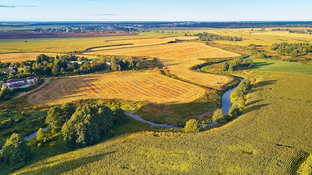 September agriculture fields aerial panorama Sunny autumn landscape Meadows river village road