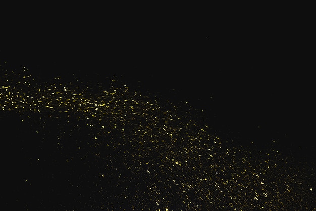 Sequins falling on dark background