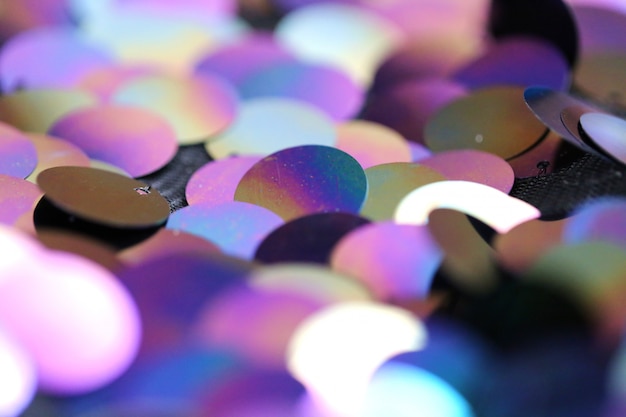 Sequins macro background.Large holographic sequins in purple and blue tones