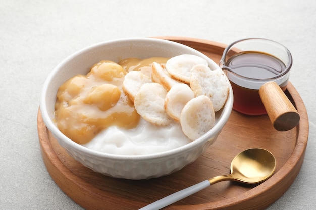 Serabi Bubur Sumsum with Candil Ubi Indonesian traditional porridge Served with palm sugar sauce