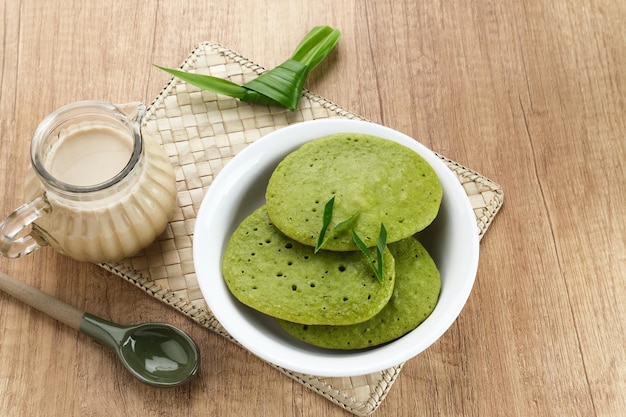 Serabi or Surabi, Indonesian pancake made of flour, rice flour, coconut milk. Served with palm sugar