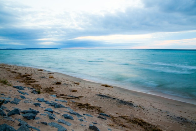 Serene Sunrise Over Lake Michigan39s Rocky Blurred Beachscape