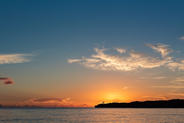 Serene sunset behind the lookout point on the coastline mountain. colorful horizon, scattered clouds