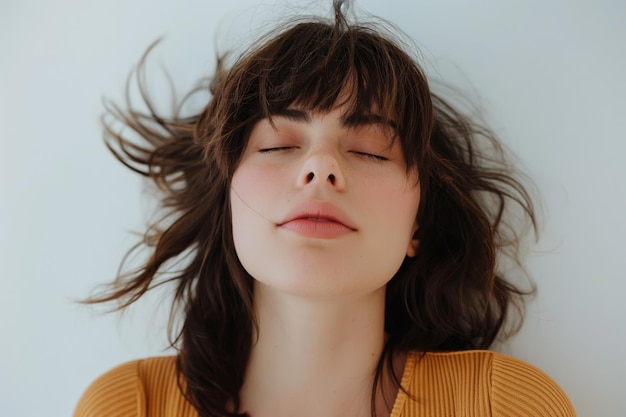 Photo serene woman with a playful messy fringe hairstyle photographed against a neutral background