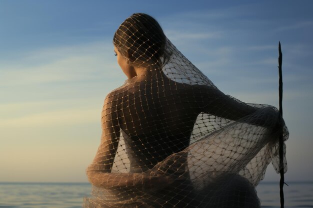 Photo serenely draped mesh fishtail net by the waters edge