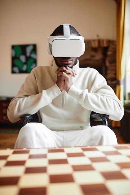 Photo serious african man in vr glasses playing video game online sitting in wheelchair