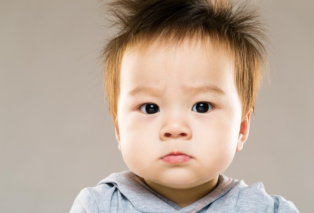 premium-photo-serious-baby-boy