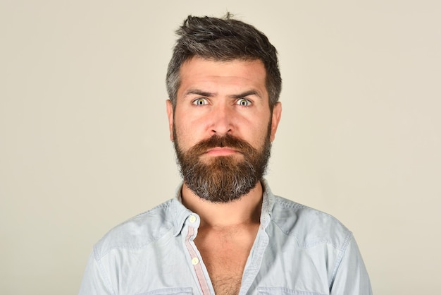 Serious bearded man man with long beard and mustache feeling and emotions close up portrait of