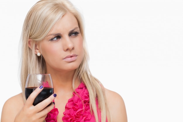 Serious blonde holding a glass of wine