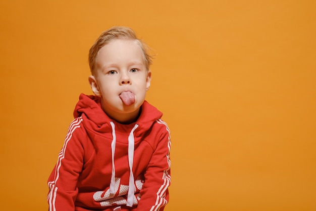 Serious boy on a yellow background