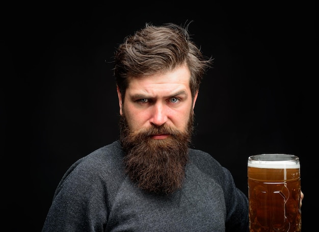 Serious brewer man in beer pub celebration oktoberfest festival concept bearded man holds mug of