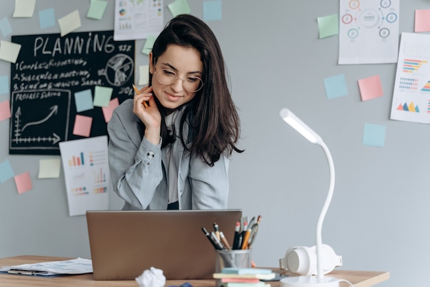 Serious business lady working on laptop in office