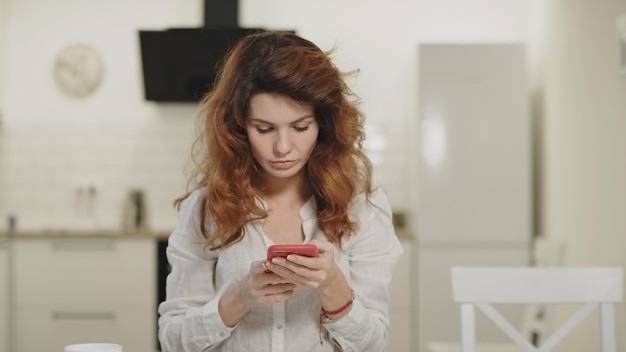 Serious business woman closing computer at remote workplace