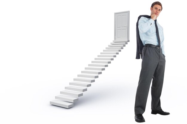 Serious businessman holding his jacket against white steps leading to closed door