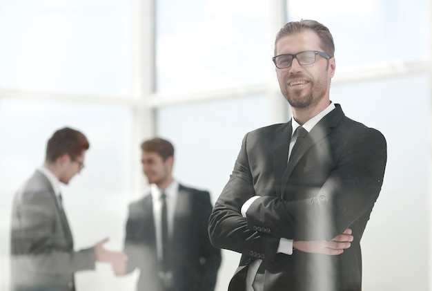 Serious businessman looks through the office windowphoto with space for text