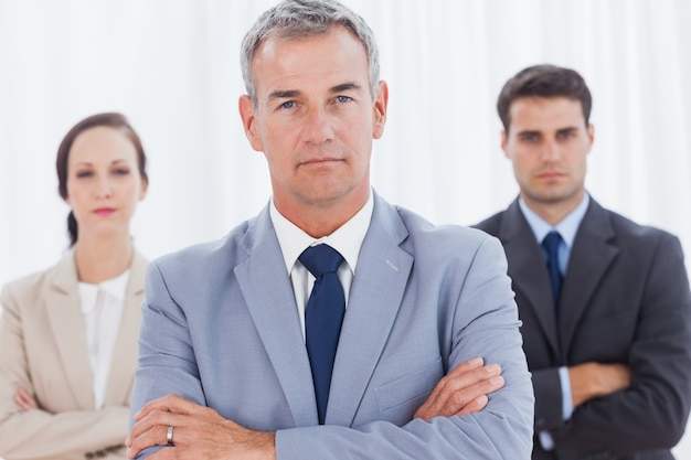 Serious businessman posing with his work team