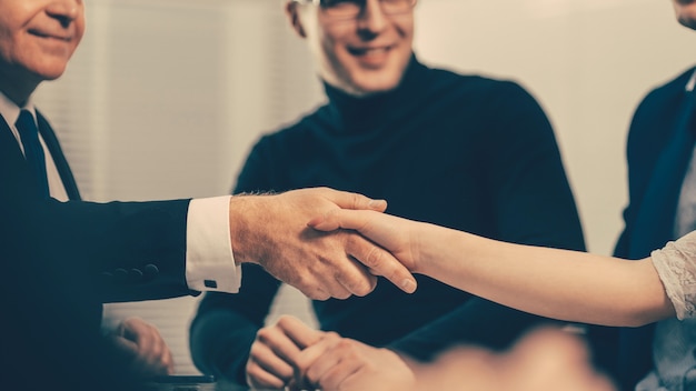 Serious businessman shaking hands with a young business man during a business meeting