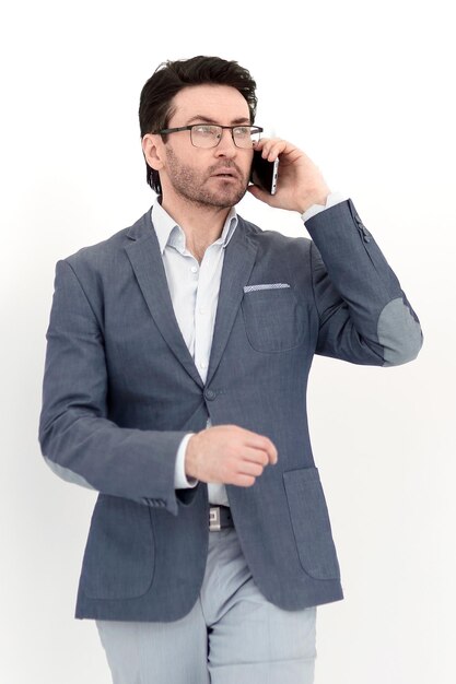 Serious businessman talking on a smartphonephoto with copy space