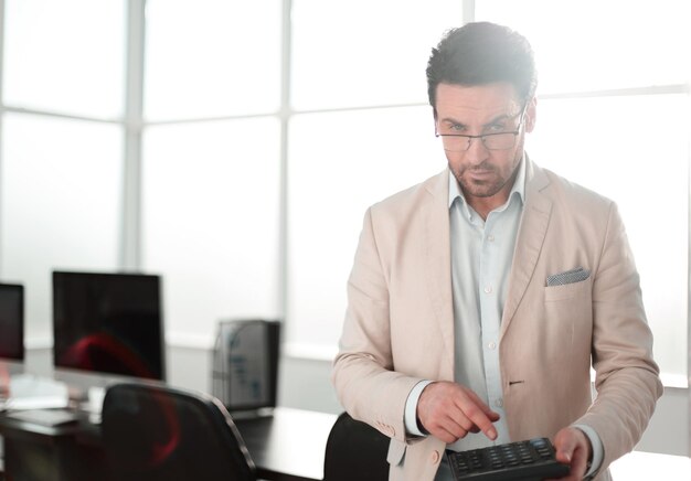 Serious businessman using calculatorphoto with copy space