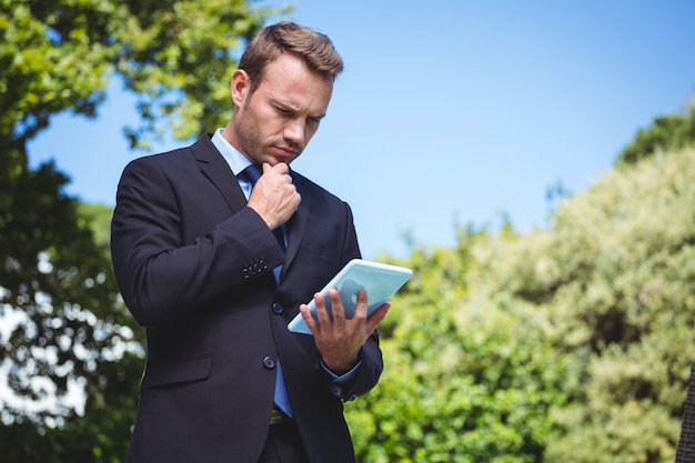 Serious businessman using tablet