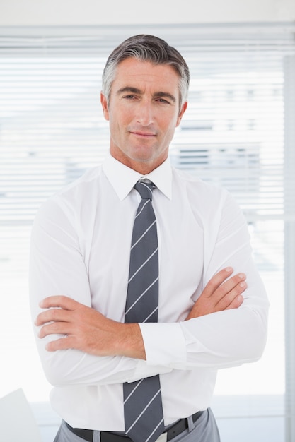 Serious businessman with folded arms