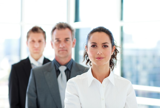 Serious businesswoman in front of her team