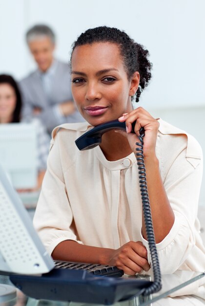 Serious businesswoman holding a phone