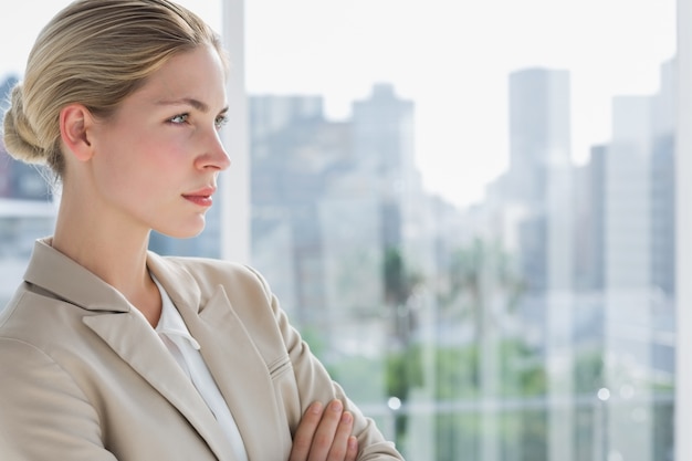 Serious businesswoman standing with arms crossed