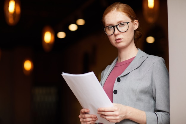 Serious businesswoman with document