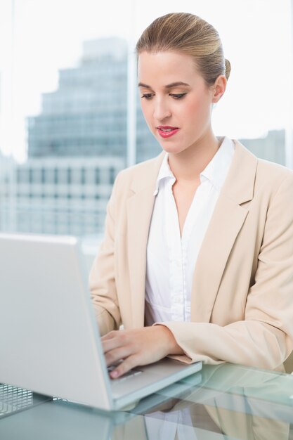 Serious businesswoman working on her laptop