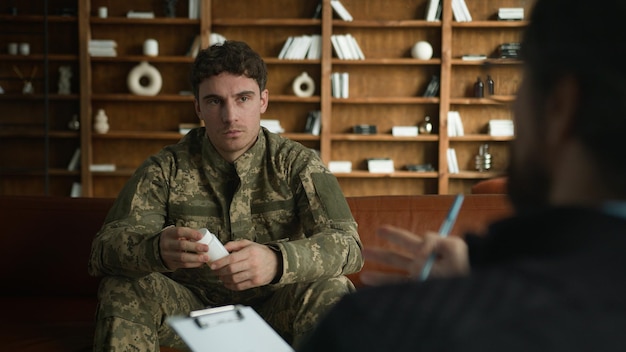 serious calm caucasian man male military army soldier officer camouflage uniform guy holding bottle