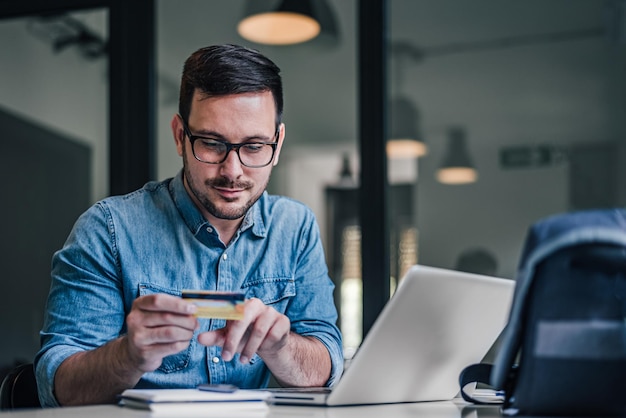 Serious caucasian man thinking about getting a loan for work