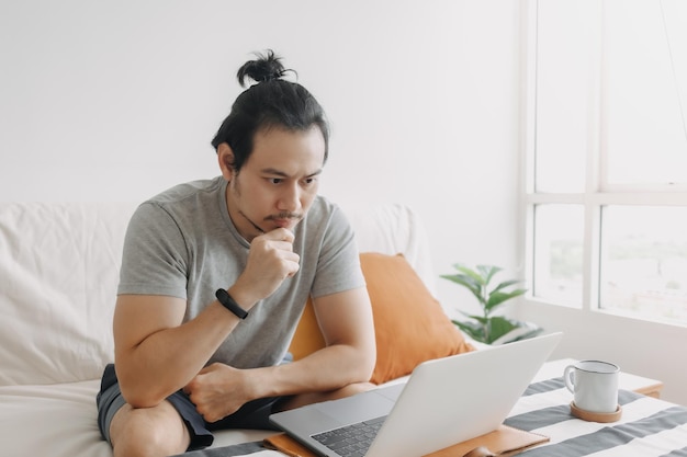 Serious creative man work in his home office apartment