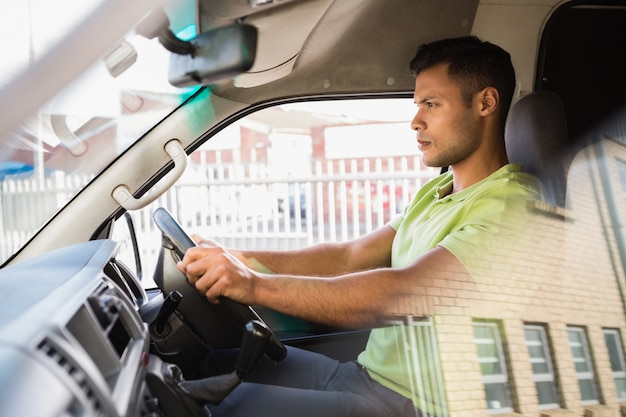 Serious delivery man driving his van