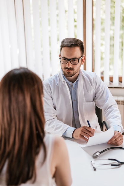 Serious doctor listening to patient