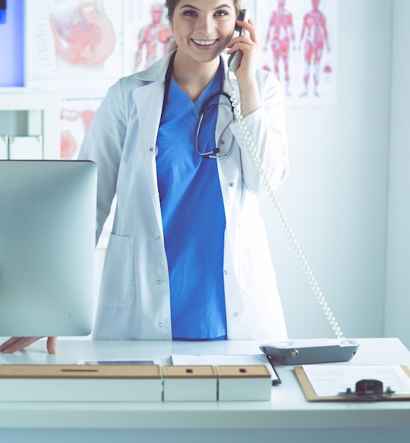 Serious doctor on the phone in her office