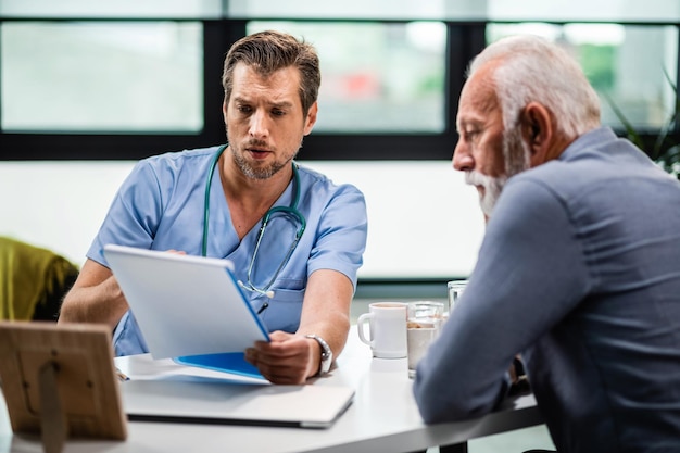 Serious doctor reading medical test results of his senior patient who came to medical appointment