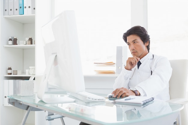 Serious doctor using the computer