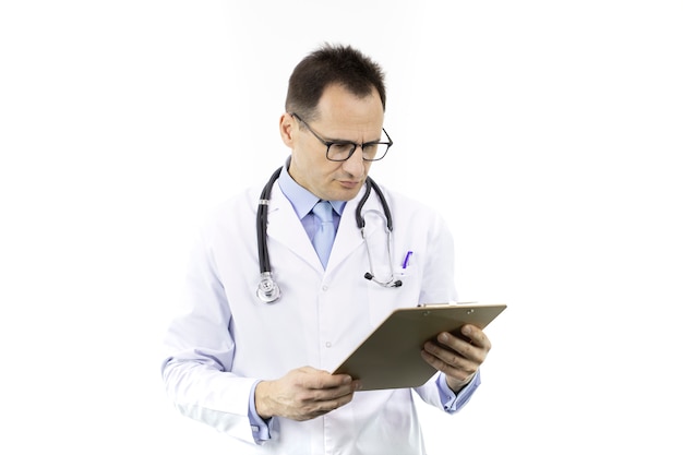 Serious doctor with stethoscope looking on clipboard with patient's diagnosis