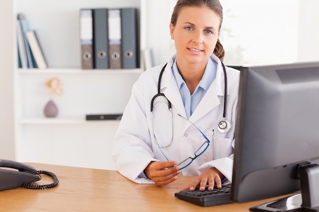 Serious doctor working with a computer