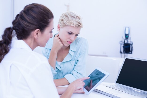 Photo serious doctors looking at digital tablet